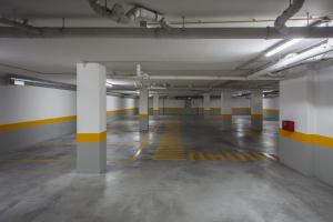 an empty parking garage with white and yellow columns at Grace Smart Design Hotel - "Hotel Anjo de Portugal" in Fátima