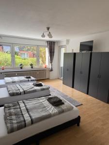 a room with four beds and a large window at Rethmann Monteurwohnung Ferienwohung in Georgsmarienhütte