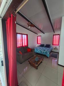 a living room with a couch and a table at Hanivai Beach Bungalow in HUH