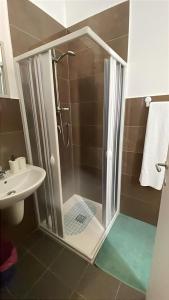 a shower with a glass door in a bathroom at A 100 passi dal mare in Bari