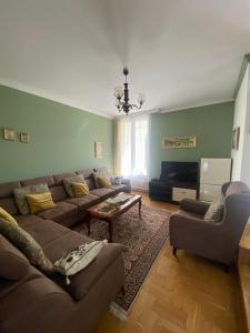 a living room with a couch and a table at Holiday Home Ilidza Rose in Sarajevo