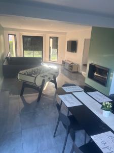 a living room with a table and a couch at Au bon moment in Rang-du-Fliers