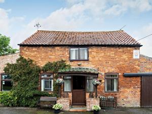 a brick house with a wooden door at 2 Bed in Spalding oc-83540 in Donington +8 photos