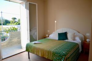 a bedroom with a bed and a sliding glass door at La Papessa in Savio di Ravenna