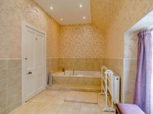 a bathroom with a bath tub and a shower at 5 Bed in Melrose oc-89348 in Newtown Saint Boswells +26 photos