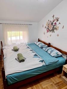 a bed with two pillows on it in a bedroom at Elena Apartment in Plužine