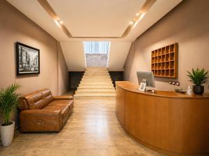 a lobby with a reception desk and a staircase at Hotel Villa Megi in Golem
