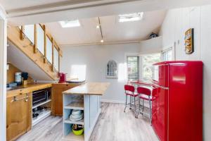 a kitchen with a red refrigerator in a room at Lighthouse at Evergreen Resort in WB in Wasaga Beach
