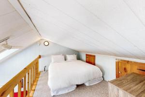 a bedroom with a white bed in a attic at Lighthouse at Evergreen Resort in WB in Wasaga Beach +10 photos