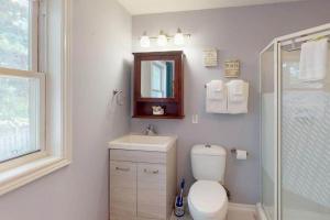 a bathroom with a toilet and a sink and a shower at Wavy Daze in Wasaga Beach in Wasaga Beach +24 photos