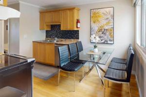 a kitchen with a glass table and chairs at Beachy Daze in Wasaga Beach in Wasaga Beach