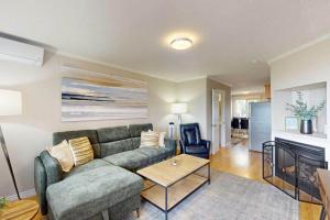 a living room with a couch and a table at Beachy Daze in Wasaga Beach in Wasaga Beach