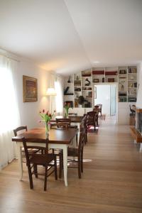 a dining room with wooden tables and chairs at Casa MaeVi in Galzignano