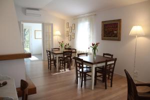a dining room with two tables and chairs and a room with a window at Casa MaeVi in Galzignano +15 photos