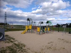 a playground with a slide in the sand at PokojeS12 in Chełm