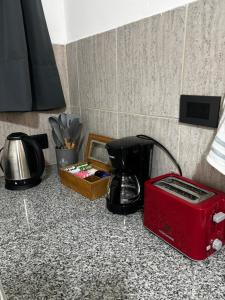 a kitchen counter with a toaster and a coffee maker at La Pampa Apartment in General Roca