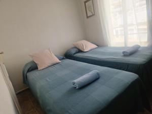 two twin beds with pillows on them in a room at MARBELLA - MIJAS in Mijas +8 photos