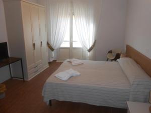 a bedroom with a bed with two towels on it at Verde Luna B in Orbetello
