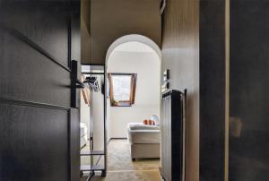 a hallway with an arched doorway to a living room at Motel Reich in Velenje +33 photos