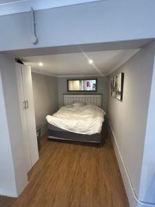 a bedroom with a bed in the middle of a room at Meerlust Cottage in Cape Town