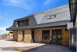 a brick building with a gray roof at Motel Reich in Velenje