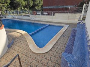a large swimming pool with a slide in the middle at casa Caithlyn in Peniscola