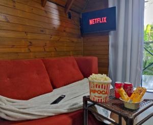 a room with a couch and a table with popcorn and snacks at Cabana com Cachoeira Privativa in Imaruí +43 photos