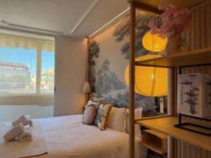 a bedroom with a bed with a painting on the wall at The Suite Collection in Fuengirola