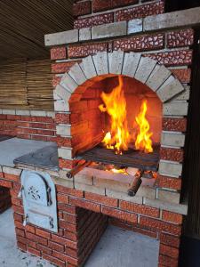 a brick oven with fire inside of it at Casa Georgeta in Câmpulung Moldovenesc