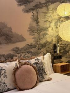 a bedroom with a wall mural of trees at The Suite Collection in Fuengirola
