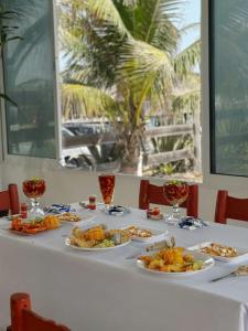 a white table with plates of food on it at Pacha beach club in Barra de Tuxpan
