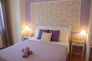 a bedroom with a bed with a stuffed animal on it at Casa MaeVi in Galzignano