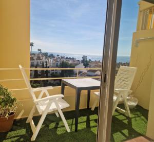 a table and chairs on a balcony with a view at MARBELLA - MIJAS in Mijas