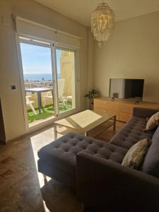 a living room with a couch and a view of the ocean at MARBELLA - MIJAS in Mijas