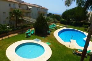 an overhead view of two swimming pools in a resort at MARBELLA - MIJAS in Mijas