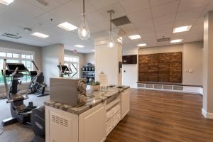 a gym with exercise equipment and a treadmill at Inn at Bay Harbor in Petoskey