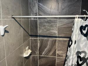 a bathroom with a tiled shower with a towel at La Bodeguita in Trinidad