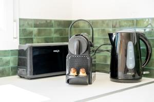 a toaster sitting on a counter next to a microwave at Villa Santa - Piscine - Wifi - Proche Ventoux - idéal Cyclistes in Mormoiron +15 photos