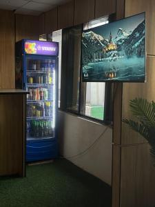 a television in a room with a refrigerator at Montevar Hotel in Benin City