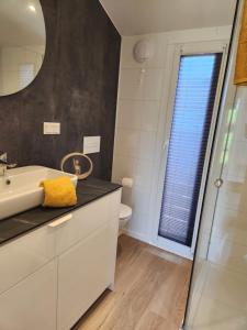 a bathroom with a sink and a mirror at Bei Herze - Tiny Wohnen im Odenwald in Bad König +25 photos