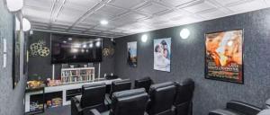 a waiting room with black chairs and a flat screen tv at Isle be sea'n you in Rodanthe