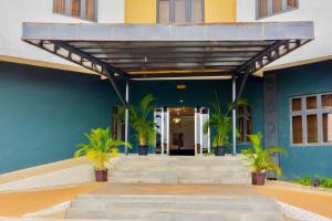 a building with stairs and plants in front of it at Diplomats Enclave Suites in Jikoyi