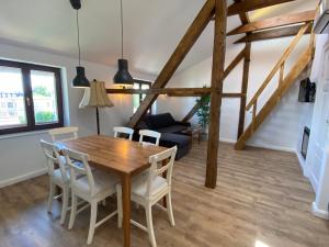 a dining room with a wooden table and chairs at Villa Pippingsburg am Strand in Ahlbeck