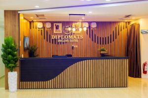 a lobby with a reception desk in a building at Diplomats Enclave Suites in Jikoyi +28 photos
