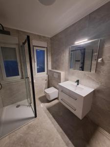 a bathroom with a sink and a toilet and a shower at House Veljko in Vrhovine