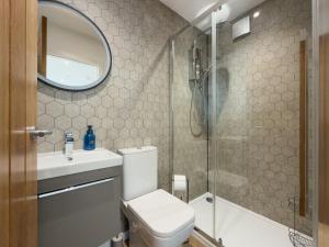 a bathroom with a toilet and a sink and a shower at Bothan By The Bay, Benbecula in Grimsay +35 photos