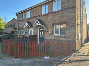 a house with a red fence in front of it at Stony Apartment House in Doncaster