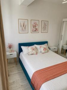 a bedroom with a bed with two pillows at Noblesse residence - parking Militari residence Chiajna Dudu in Chiajna