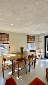 a dining room with a wooden table and chairs at Tidal Nest - North Sea Stays in Wenduine
