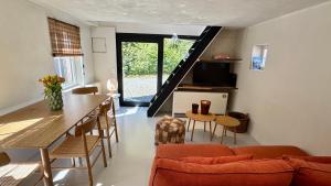 a living room with a table and a dining room at Tidal Nest - North Sea Stays in Wenduine